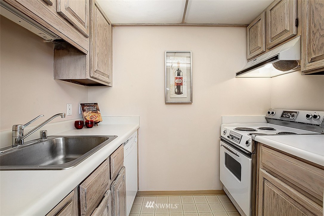 2201 3rd Avenue, Unit 1001 Seattle, WA 98121 - Photo 8 of 20 a kitchen with stainless steel appliances granite countertop a sink and a stove