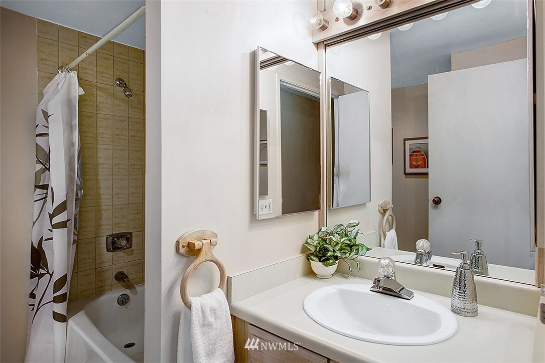 2201 3rd Avenue, Unit 1001 Seattle, WA 98121 - Photo 10 of 20 a bathroom with a sink and mirror