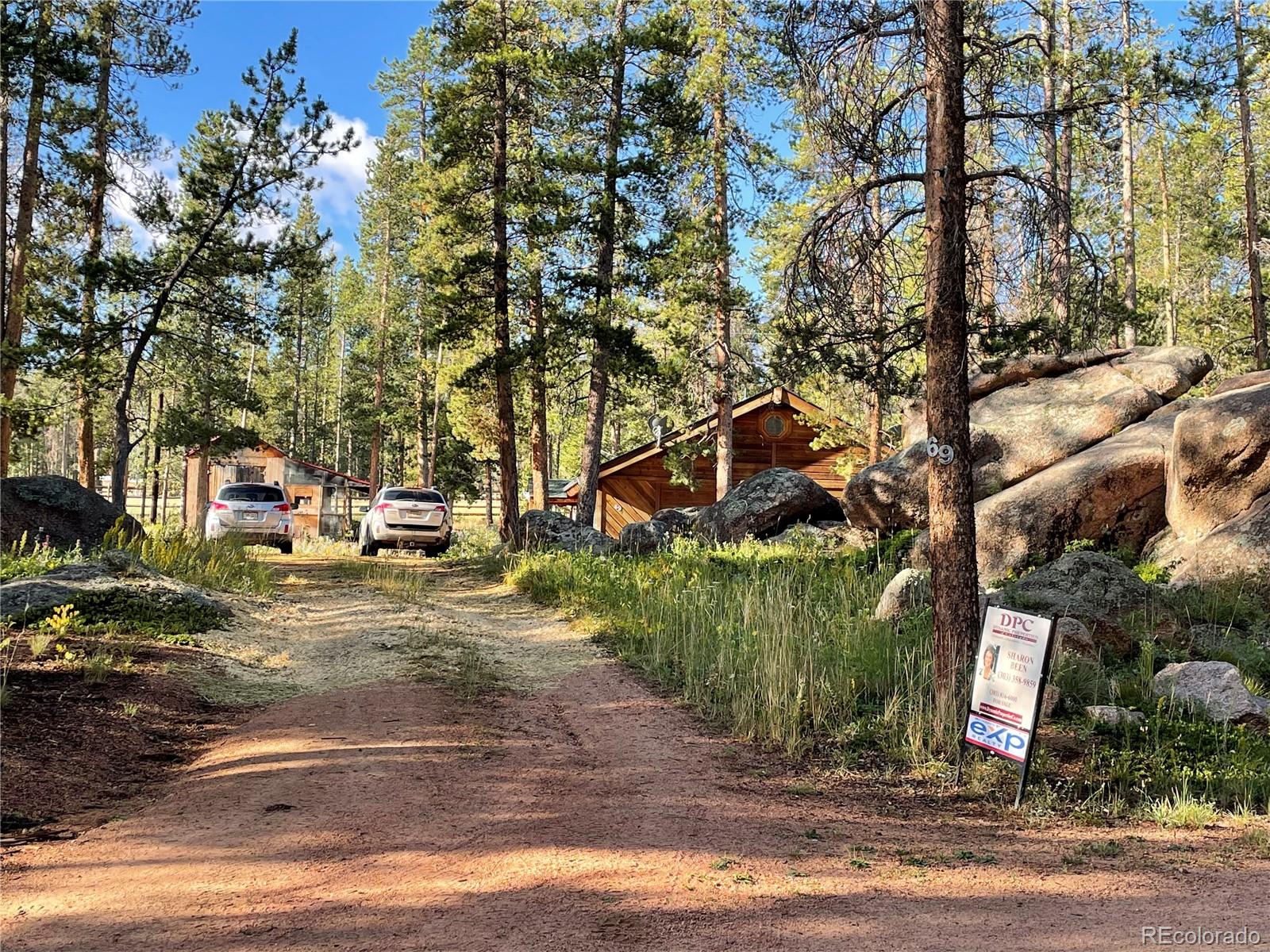 69 County Road 114 Bailey, CO 80421 - Photo 2 of 34 a street sign on a sidewalk next to a road