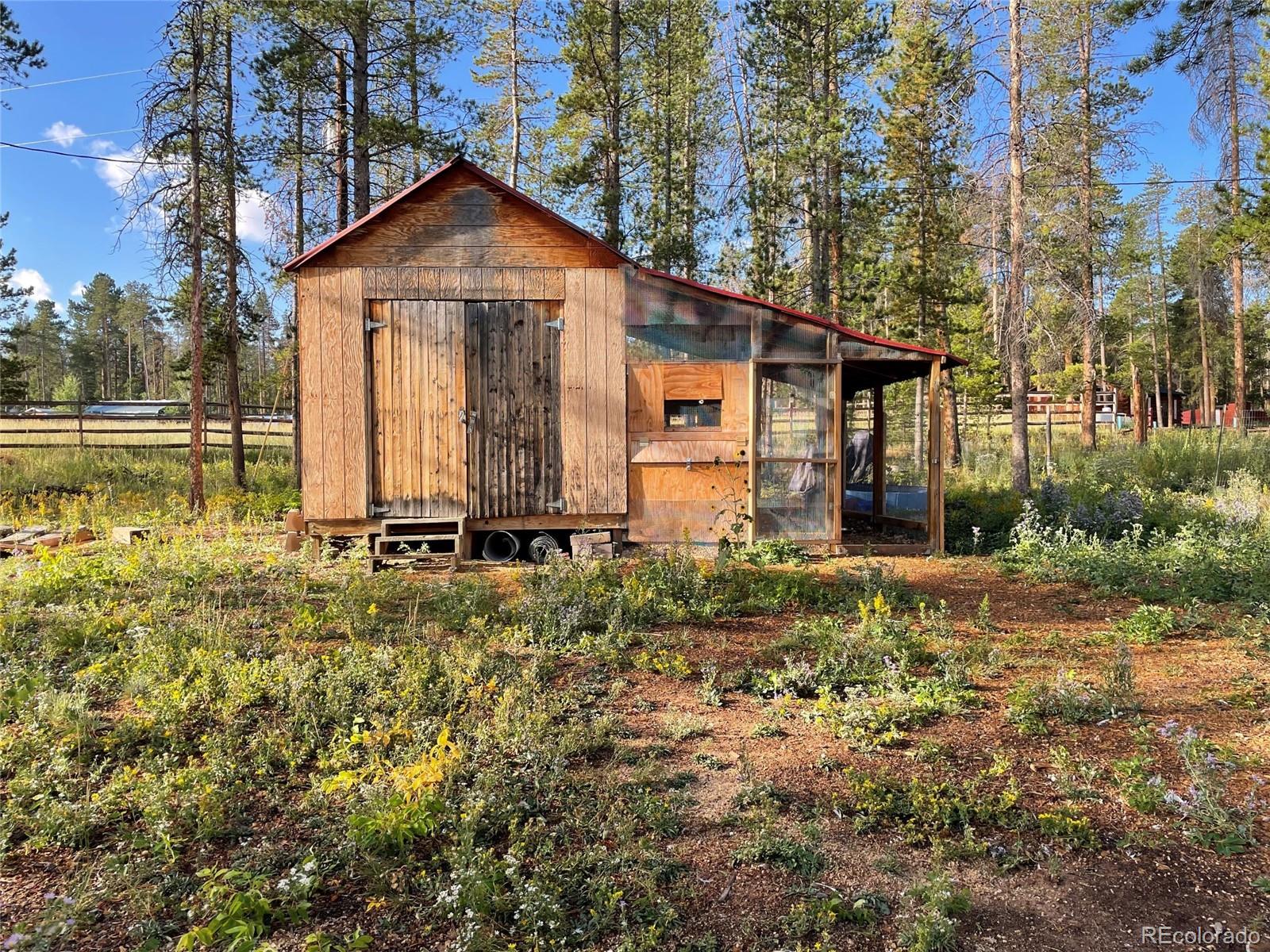 69 County Road 114 Bailey, CO 80421 - Photo 22 of 34 a front view of a house with garden