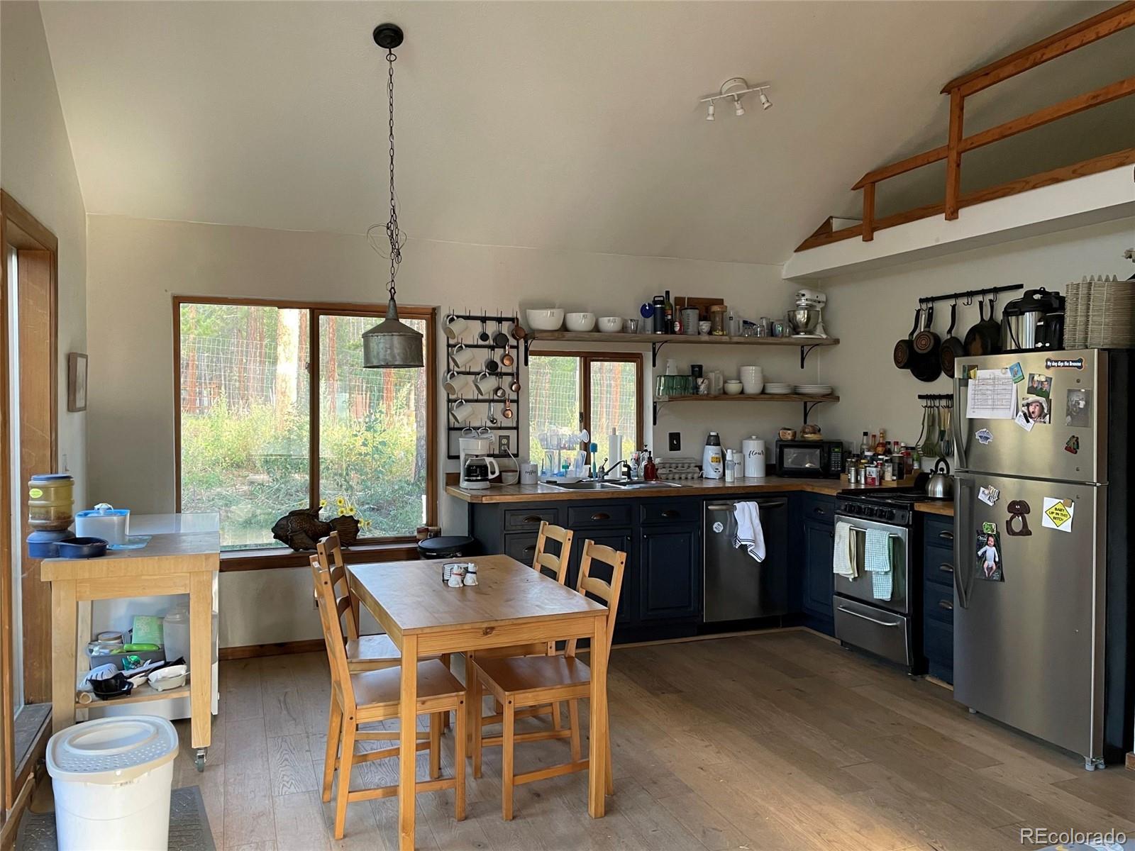 69 County Road 114 Bailey, CO 80421 - Photo 4 of 34 a kitchen with stainless steel appliances granite countertop a sink a stove and refrigerator