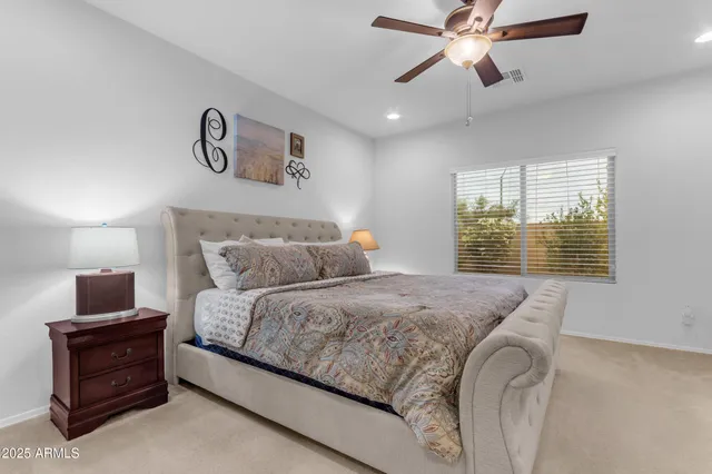 a bedroom with bed and a flat screen tv