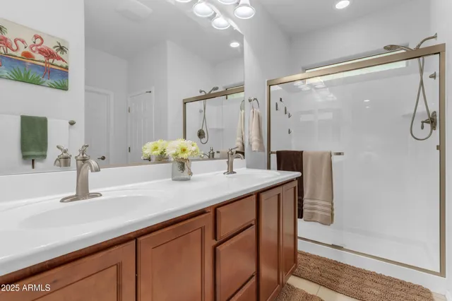 a bathroom with a double vanity sink and a mirror