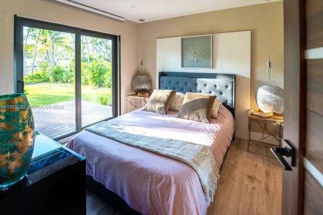 a bed sitting in a bedroom next to a window