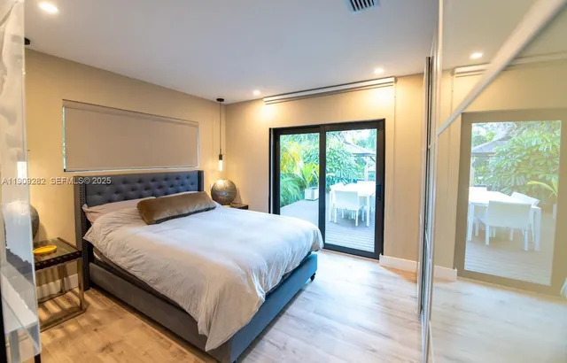 a bedroom with a large bed and a large window