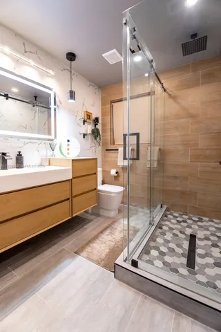 a bathroom with a sink a mirror and a shower