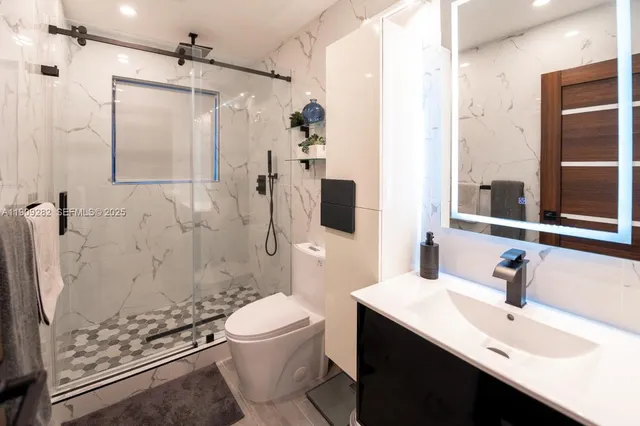 a bathroom with a sink toilet and shower