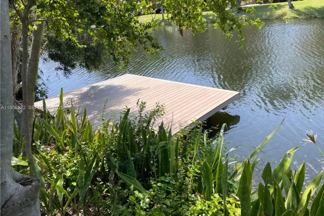 a view of a backyard of a house with a lake view