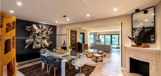 a living room with furniture a fireplace and a flat screen tv