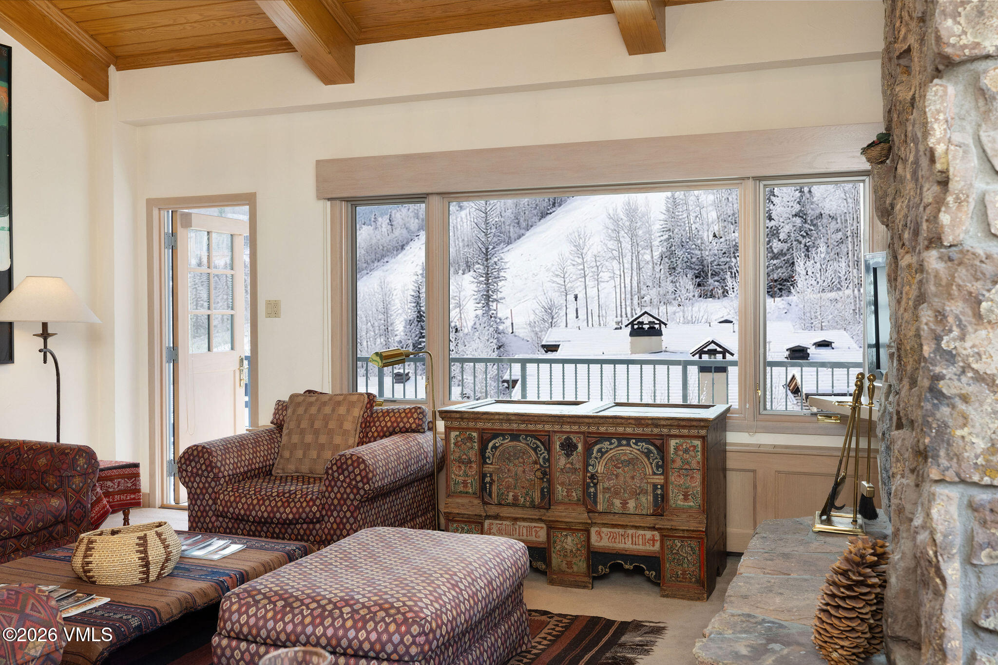 200 Vail Road, Unit 799 Vail, CO 81657 - Photo 5 of 32 a balcony with furniture and a floor to ceiling window