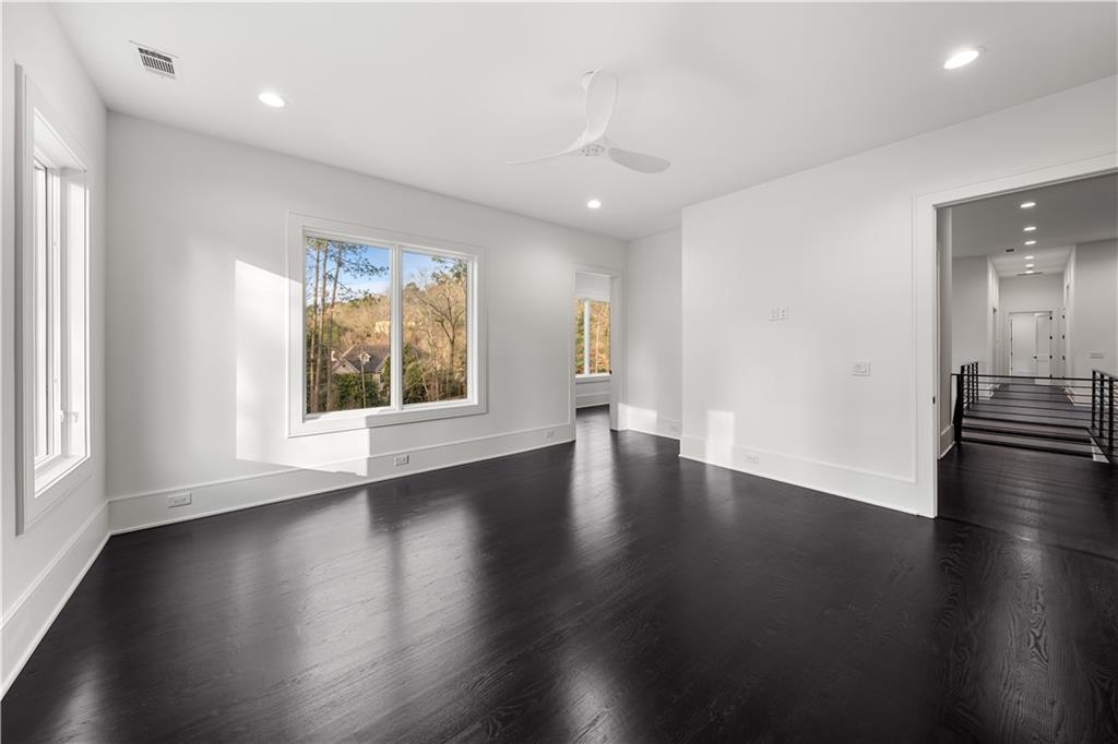 5211 Powers Ferry Road Northwest Sandy Springs, GA 30327 - Photo 86 of 106 an empty room with wooden floor and windows