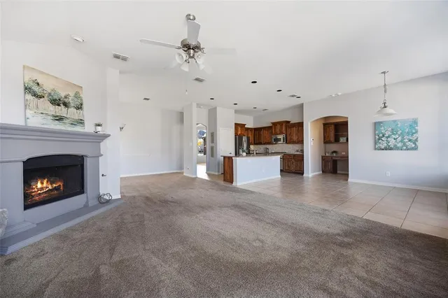 a large kitchen with stainless steel appliances granite countertop a stove sink and cabinets