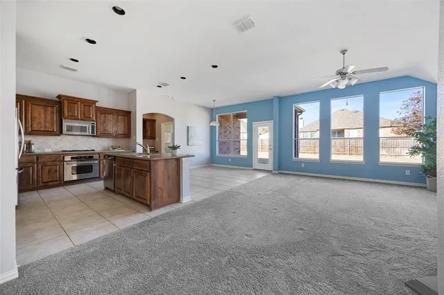 a kitchen with stainless steel appliances granite countertop a stove and a refrigerator