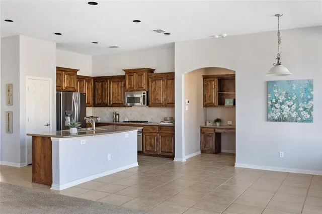a view of kitchen with windows and refrigerator