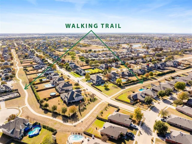 an aerial view of a house with a swimming pool