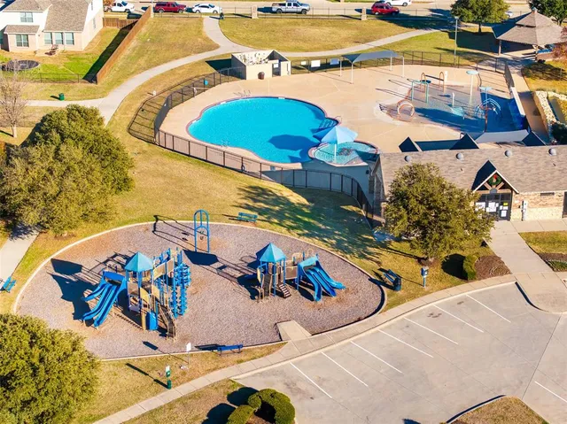 an aerial view of a house with a swimming pool