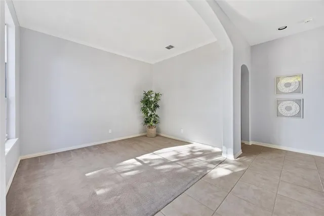 an empty room with windows and entrance