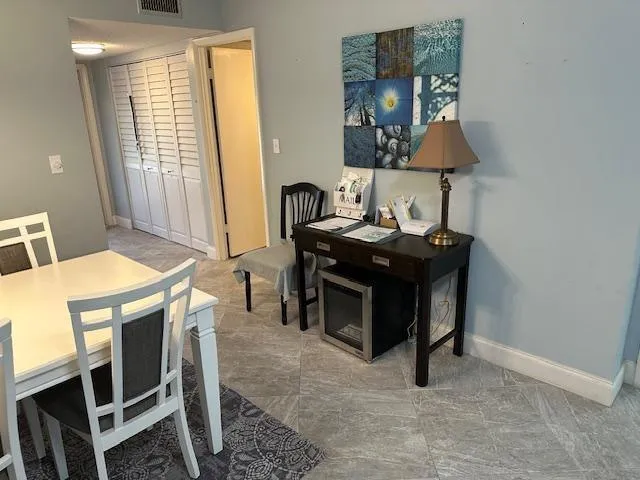 a view of a workspace with furniture and a window