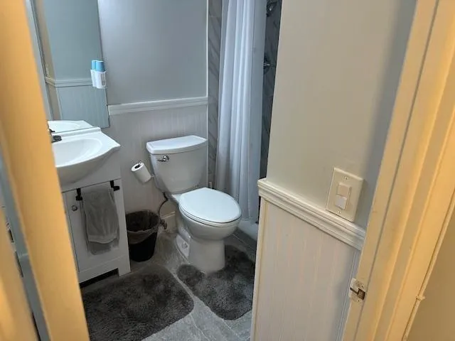 a white toilet sitting next to a sink