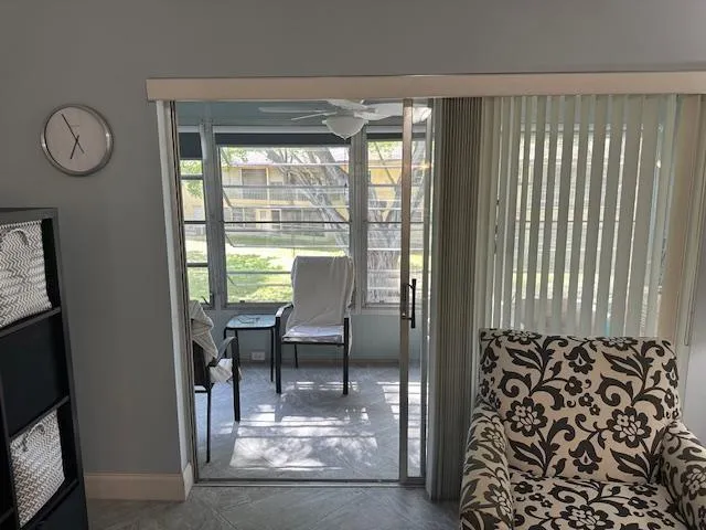 a view of a livingroom with furniture and a window