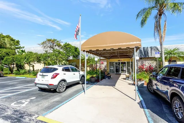 a view of a cars park in front of a building