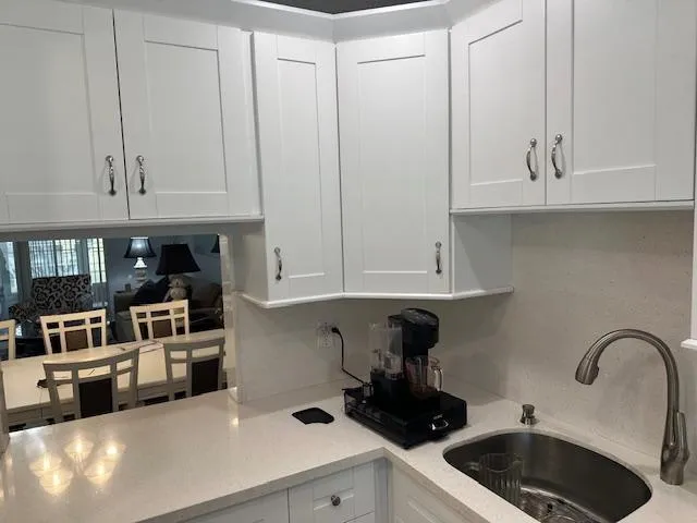 a kitchen with stainless steel appliances granite countertop a sink and cabinets