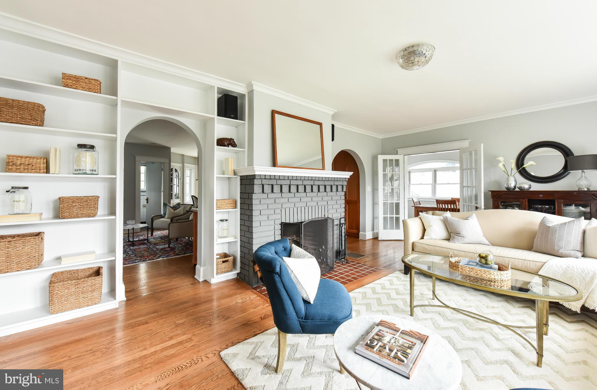 5517 Broad Branch Road Northwest Washington, DC 20015 - Photo 4 of 25 a living room with furniture a fireplace and wooden floor