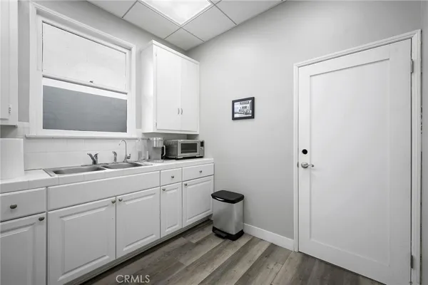 a kitchen with a sink and refrigerator