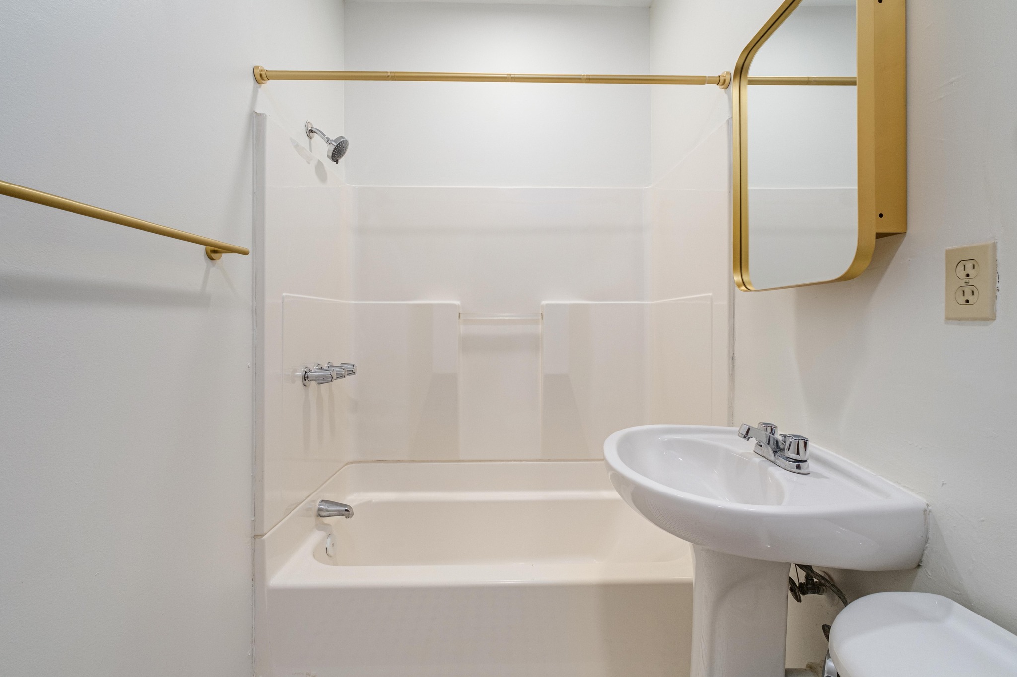 2012 Enfield Road, Unit B Austin, TX 78703 - Photo 16 of 20 A well-maintained bathroom with a classic pedestal sink and shower-over-tub combination.