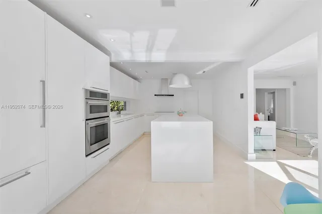 a kitchen with refrigerator and cabinets