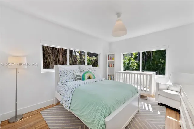 a bed room with a bed and a large window