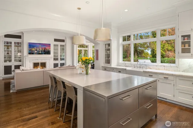 a kitchen with a table chairs sink and cabinets
