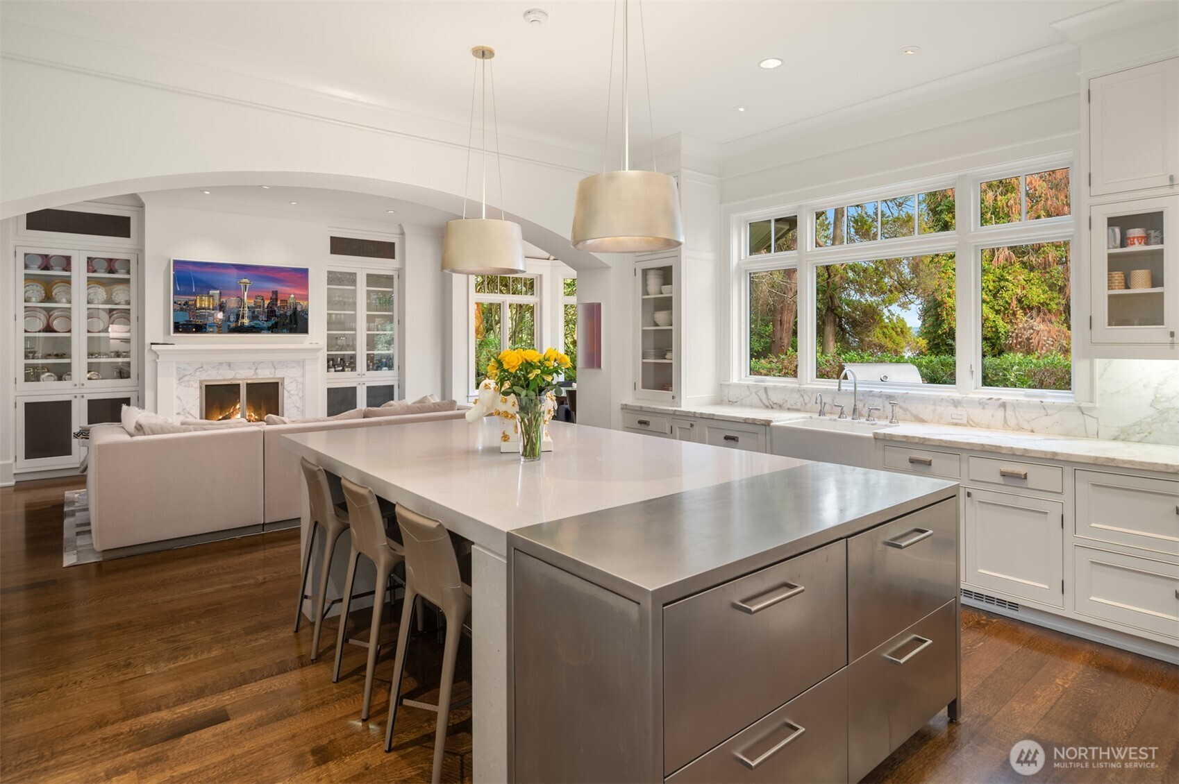 3814 East John Street Seattle, WA 98112 - Photo 11 of 26 a kitchen with a table chairs sink and cabinets