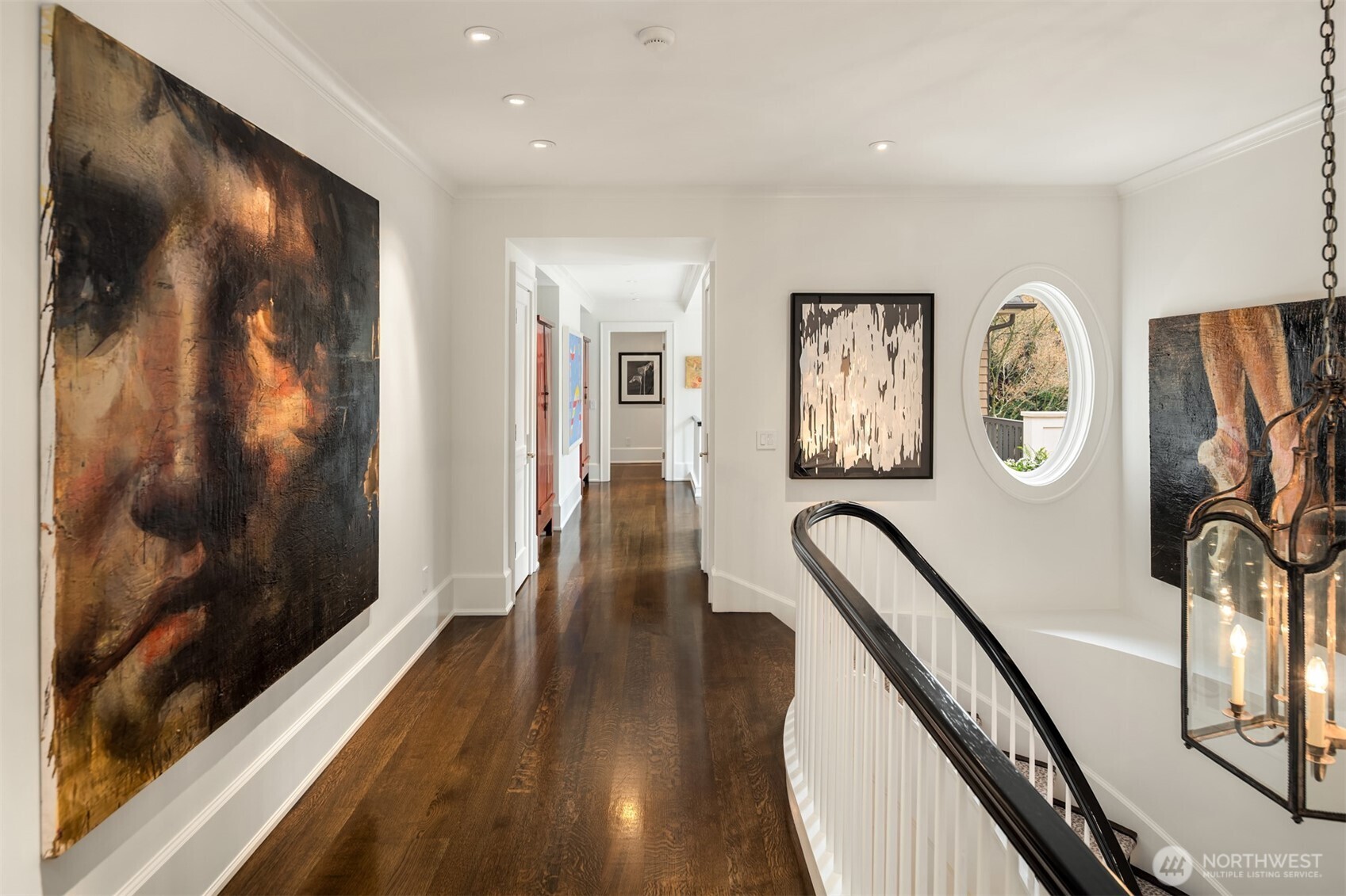 3814 East John Street Seattle, WA 98112 - Photo 16 of 26 a view of a hallway with wooden floor and stairs