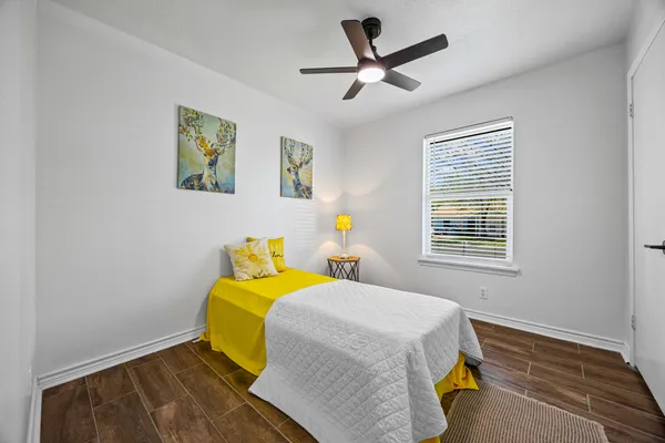 a bedroom with a bed and a window