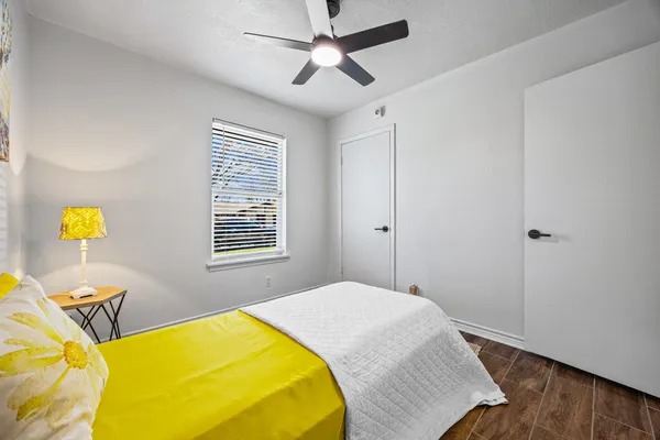 a bedroom with a bed and wooden floor