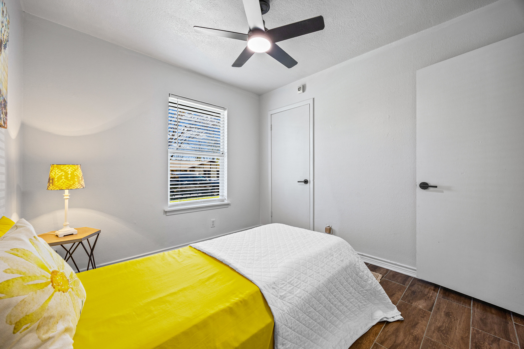6010 Waycross Drive Austin, TX 78745 - Photo 15 of 22 a bedroom with a bed and wooden floor