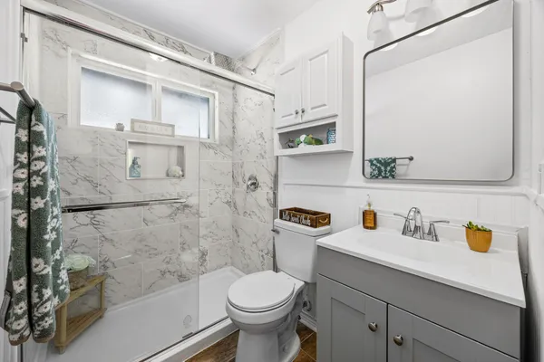 a bathroom with a sink toilet and shower