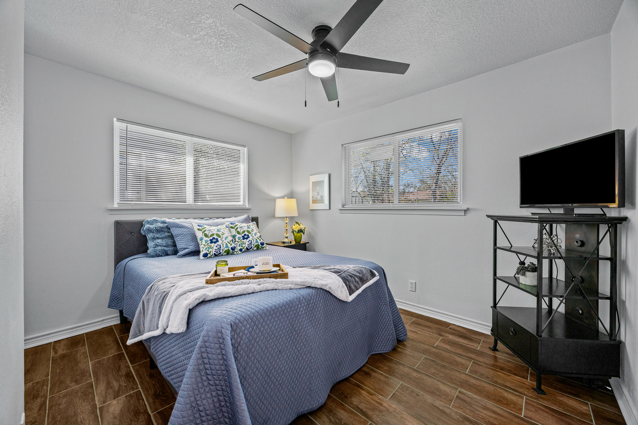 6010 Waycross Drive Austin, TX 78745 - Photo 17 of 22 a bedroom with bed tv and wooden floor