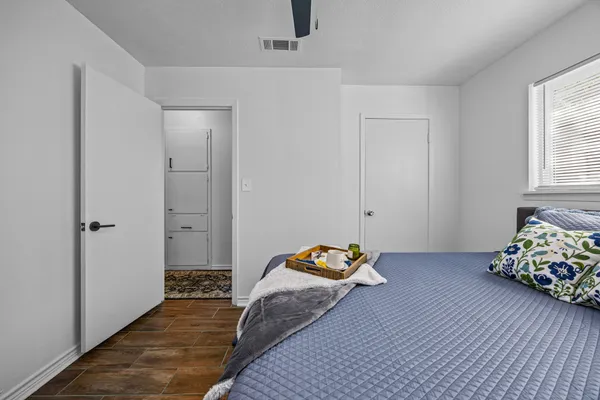 a bedroom with bed and hallway