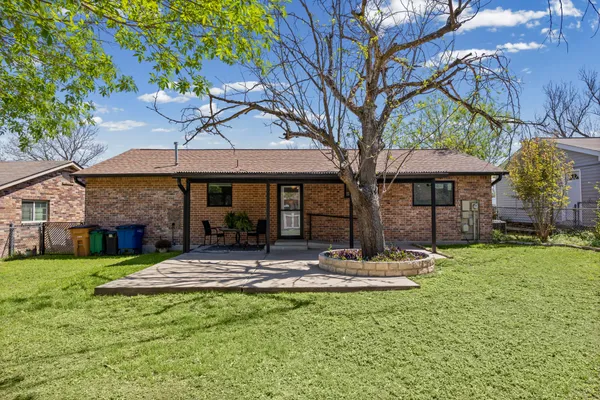 a front view of a house with yard and green space