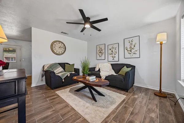 a living room with furniture and a clock