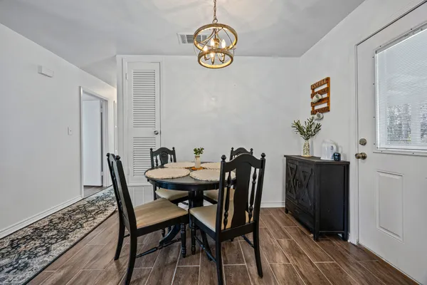 a view of a dining room with furniture wooden floor and a chandelier