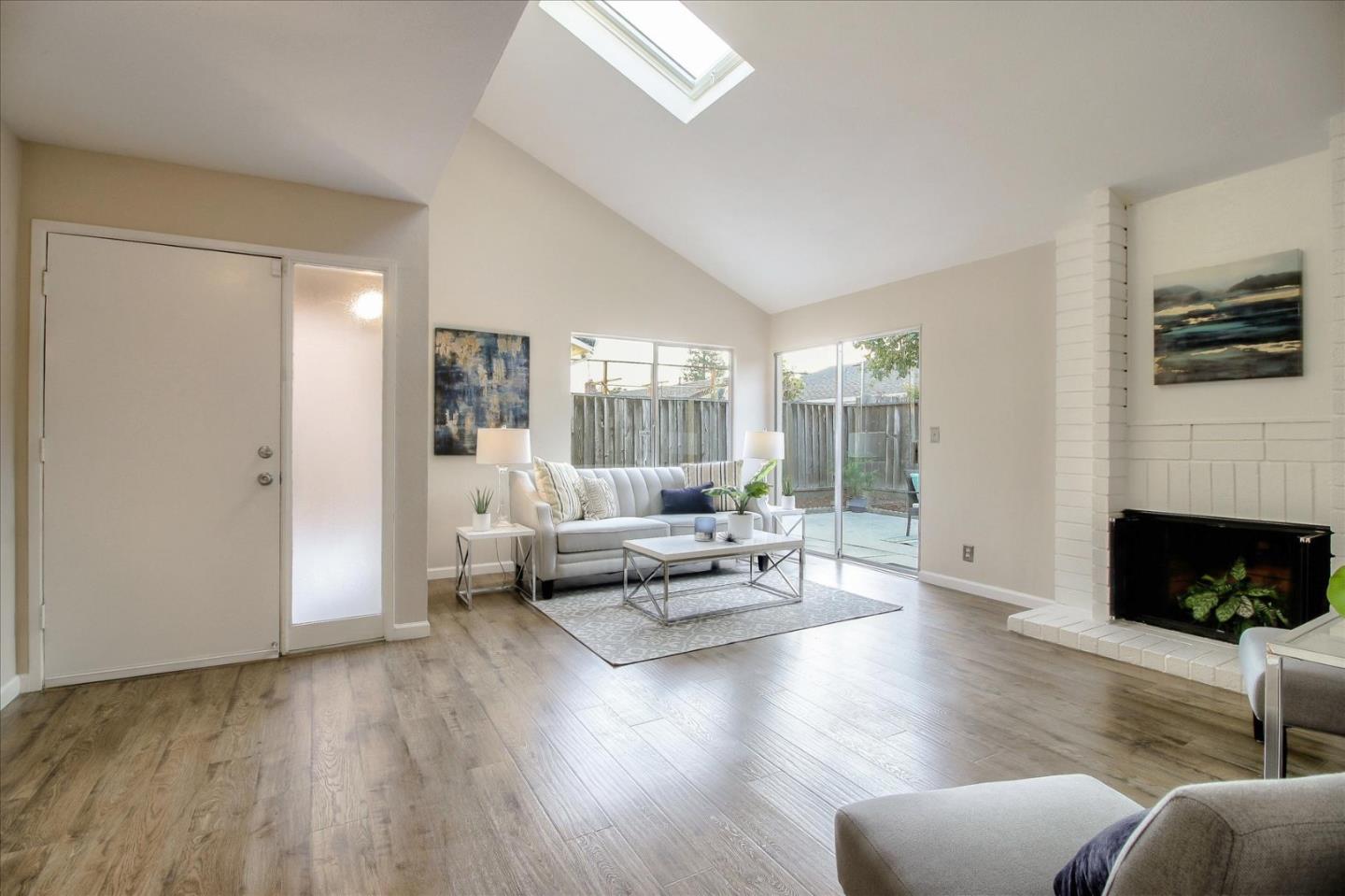 5278 Garrison Circle San Jose, CA 95123 - Photo 3 of 31 a living room with furniture floor to ceiling window and a fireplace