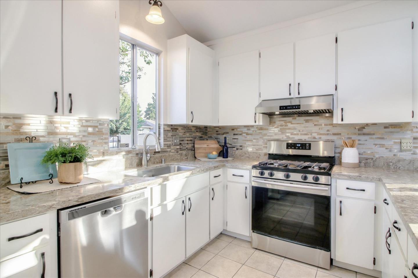5278 Garrison Circle San Jose, CA 95123 - Photo 10 of 31 a kitchen with stainless steel appliances granite countertop a stove a sink and white cabinets