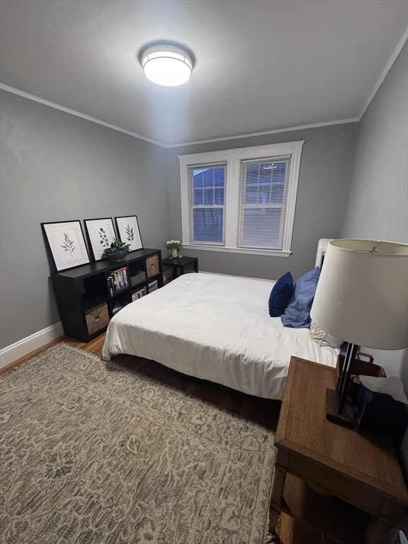 35 Mendelssohn Street, Unit 2 Boston, MA 02131 - Photo 5 of 13 a bedroom with a bed and wooden floor
