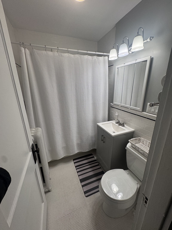 35 Mendelssohn Street, Unit 2 Boston, MA 02131 - Photo 10 of 13 a bathroom with a sink toilet and shower