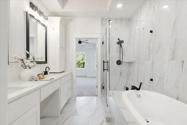 a bathroom with a tub sink shower and mirror