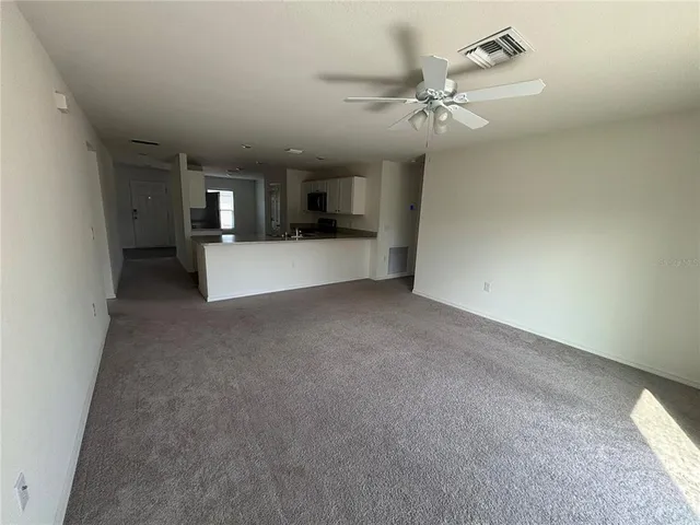a view of a room with a ceiling fan