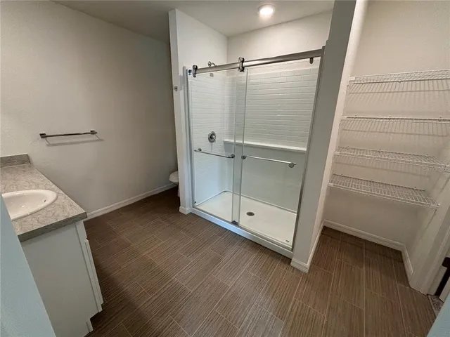 a bathroom with a glass door shower